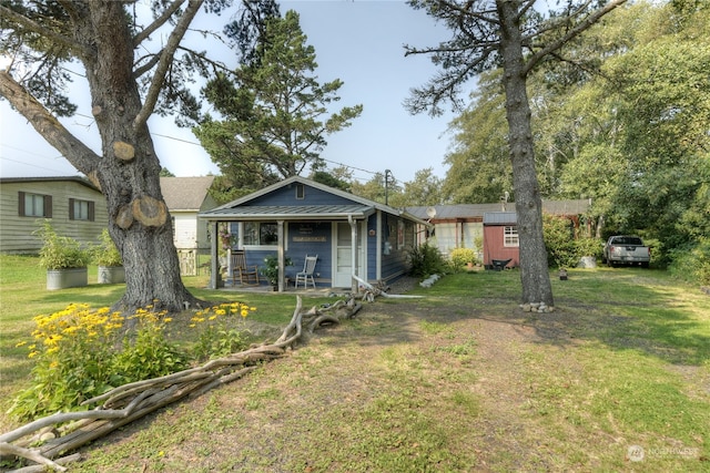 rear view of property featuring a yard