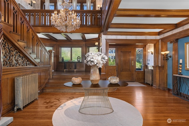 interior space with radiator, an inviting chandelier, hardwood / wood-style floors, and beam ceiling