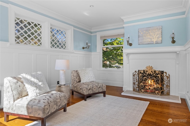 living area with dark hardwood / wood-style floors and crown molding