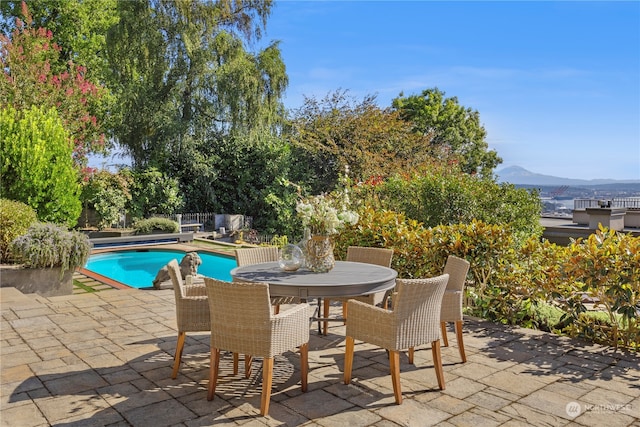 view of pool with a patio and a mountain view