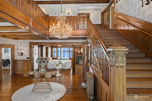 interior space featuring a notable chandelier, beamed ceiling, and dark wood-type flooring