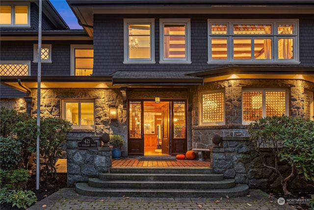 view of exterior entry with covered porch