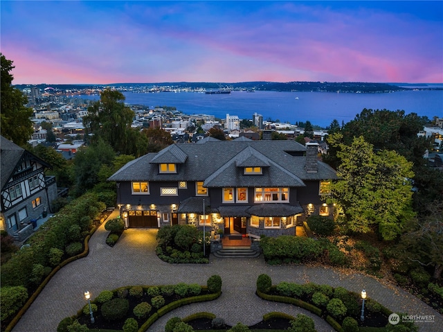 back house at dusk with a water view