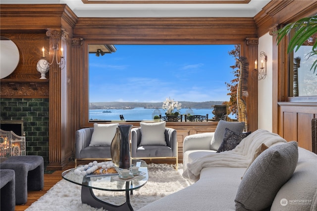 living room with a water view and hardwood / wood-style flooring