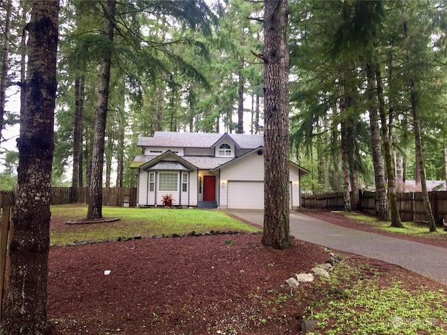 view of front of property featuring a front lawn and a garage