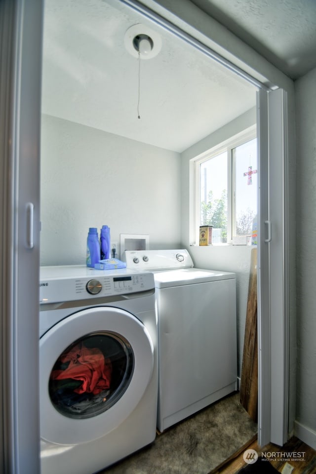 clothes washing area with washer and dryer