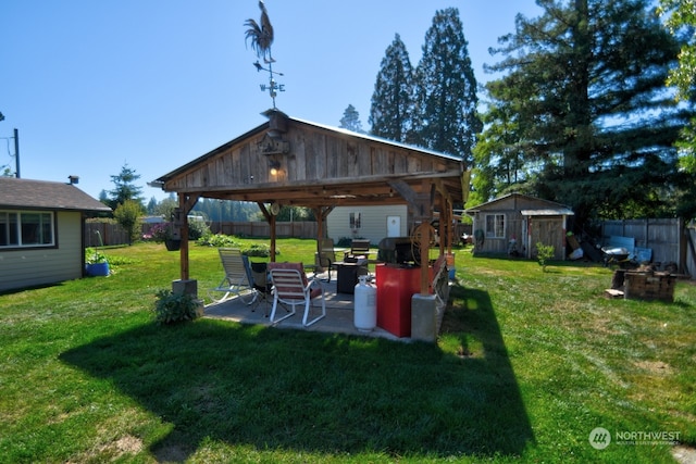 view of yard featuring a storage shed, a patio area, and a gazebo