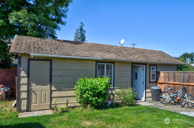 view of front facade with a front lawn and a storage unit