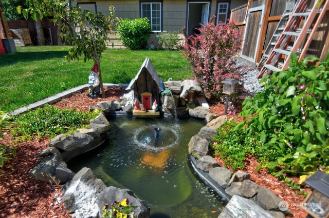 view of yard featuring a small pond