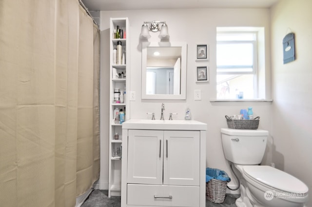 bathroom featuring vanity, toilet, and curtained shower