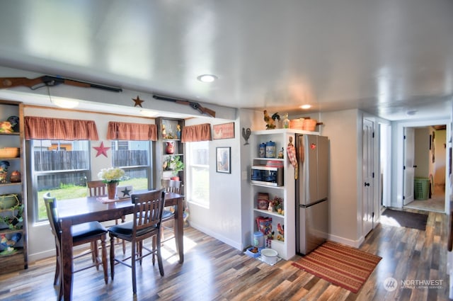 dining room with dark hardwood / wood-style flooring