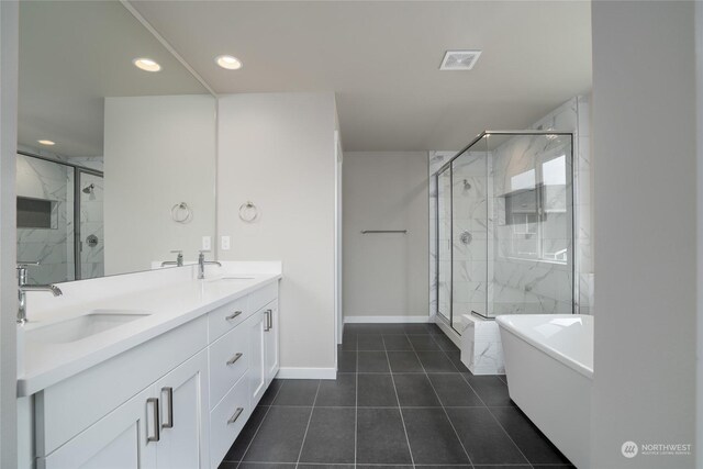 bathroom featuring vanity, tile patterned flooring, and plus walk in shower