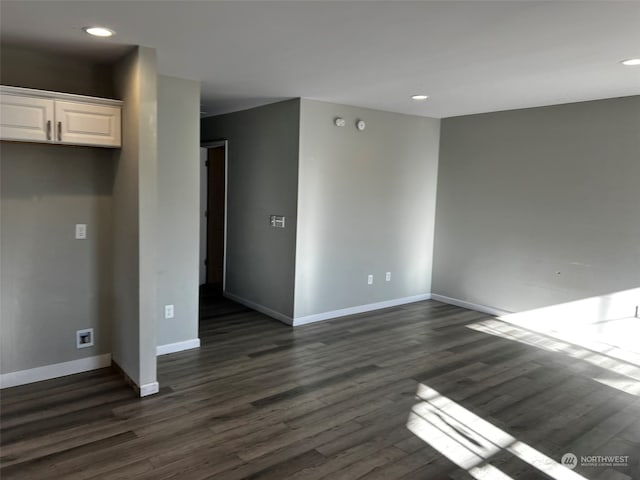 empty room featuring dark wood-type flooring