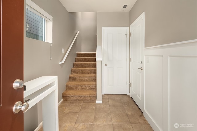 stairway featuring tile patterned flooring