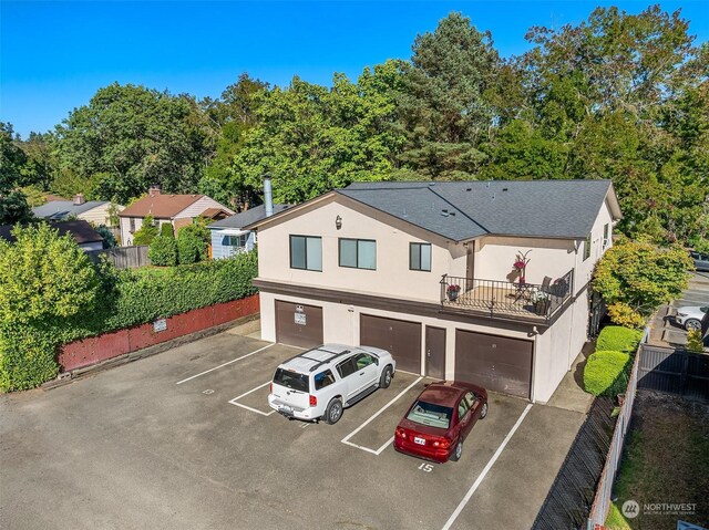 exterior space featuring a balcony and a garage