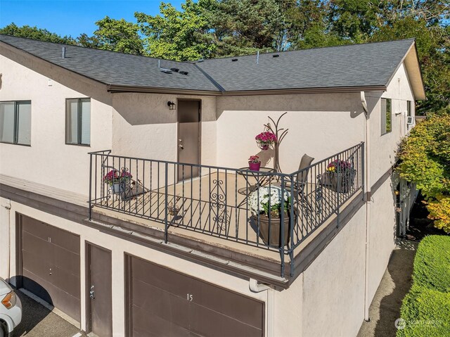 view of home's exterior with a balcony and a garage