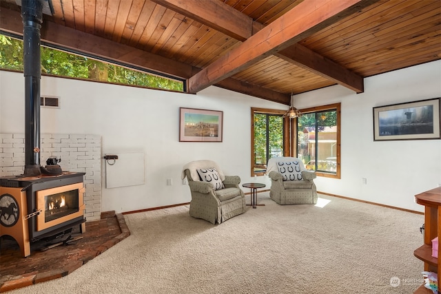 living area with carpet flooring, a wood stove, beamed ceiling, and wooden ceiling