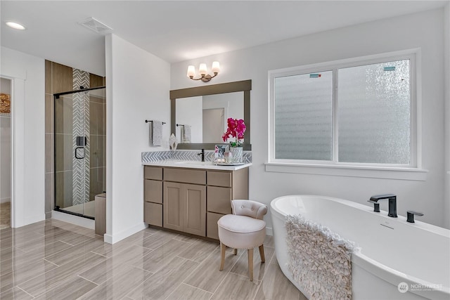 full bath with wood finish floors, a soaking tub, visible vents, a shower stall, and vanity