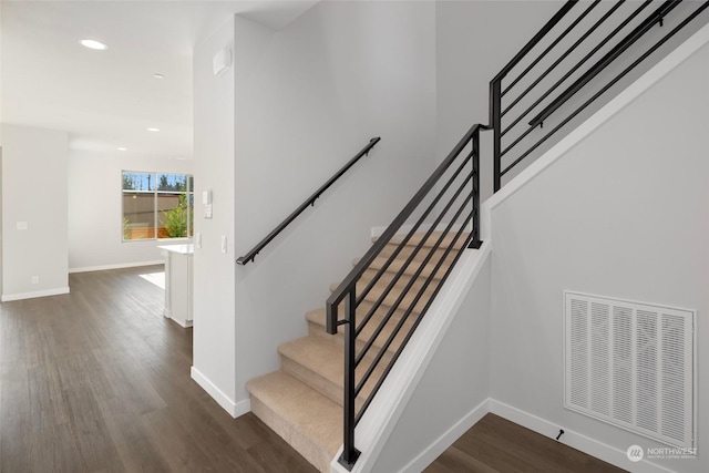 staircase with recessed lighting, wood finished floors, visible vents, and baseboards