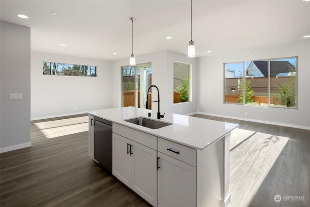 kitchen with a sink, open floor plan, recessed lighting, stainless steel dishwasher, and dark wood-style flooring