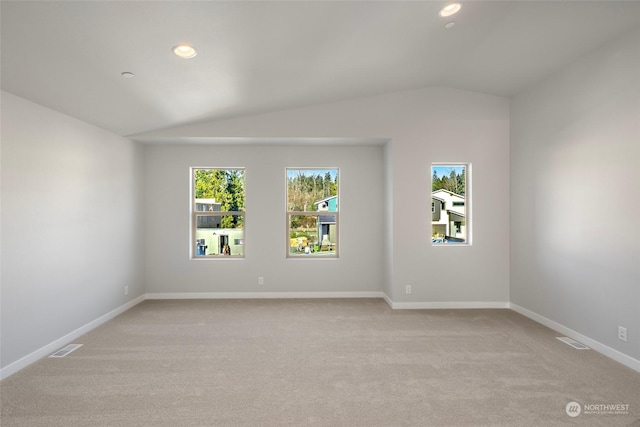 unfurnished room featuring recessed lighting, light carpet, visible vents, baseboards, and vaulted ceiling