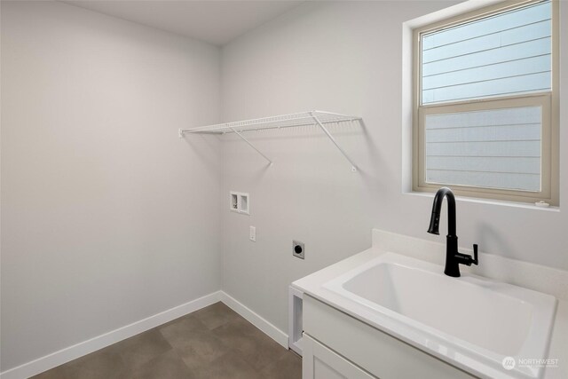 clothes washing area featuring hookup for a washing machine, baseboards, hookup for an electric dryer, and a sink