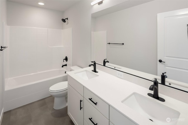 bathroom with a sink, toilet, and double vanity