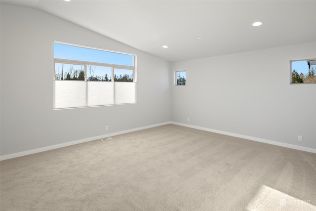 spare room with lofted ceiling, light carpet, baseboards, and recessed lighting