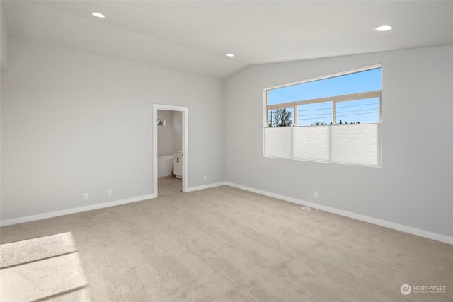 carpeted empty room with baseboards, vaulted ceiling, and recessed lighting