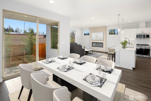 dining area featuring recessed lighting and wood finished floors