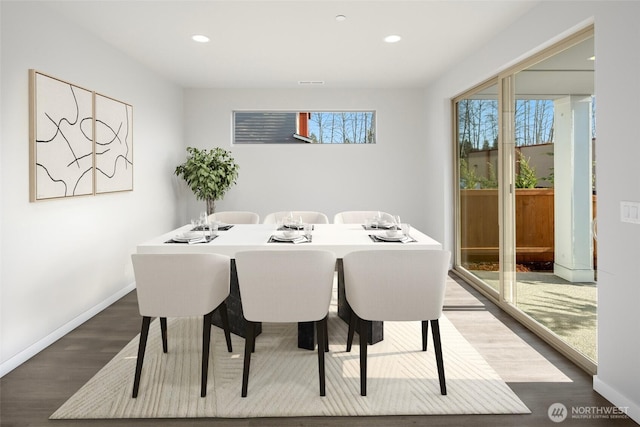 dining room with recessed lighting, baseboards, plenty of natural light, and dark wood-style floors