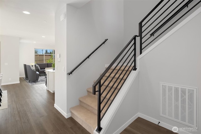 staircase with visible vents, recessed lighting, baseboards, and wood finished floors