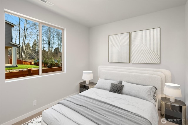 bedroom featuring visible vents, baseboards, and carpet