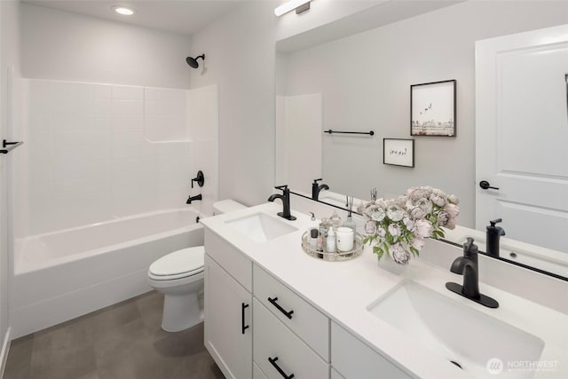 full bathroom with double vanity, shower / washtub combination, toilet, and a sink