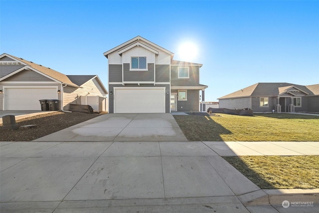 view of property featuring a garage and a front lawn