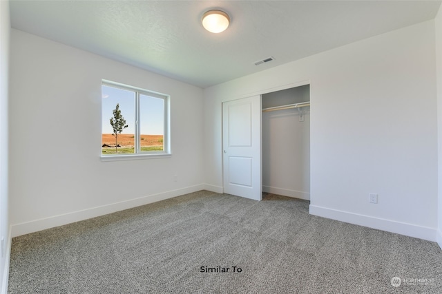 unfurnished bedroom with carpet flooring and a closet