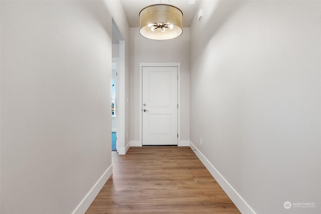 corridor with light hardwood / wood-style flooring