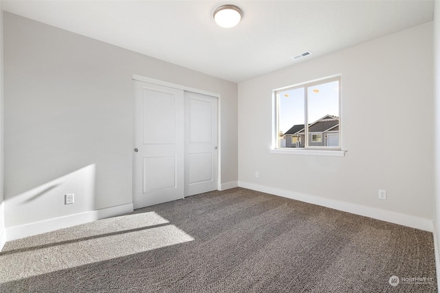 unfurnished bedroom featuring carpet and a closet