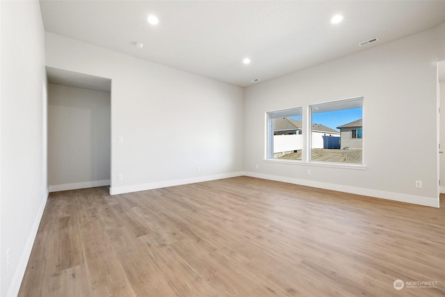 unfurnished room with light wood-type flooring