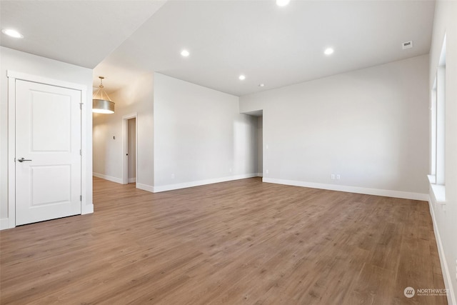 unfurnished room with hardwood / wood-style floors