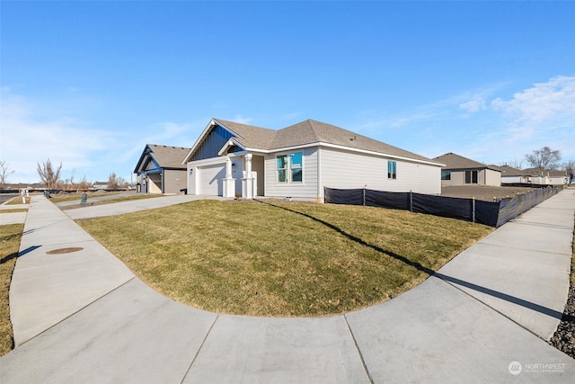 view of front of home featuring a garage and a front lawn