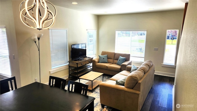 living room with an inviting chandelier and hardwood / wood-style flooring