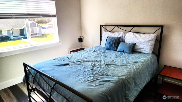 bedroom with hardwood / wood-style floors