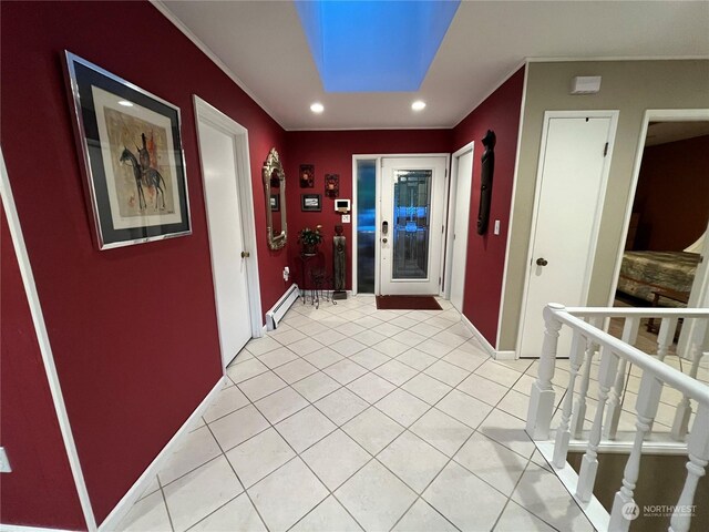 hall featuring a skylight, a baseboard radiator, and light tile patterned flooring