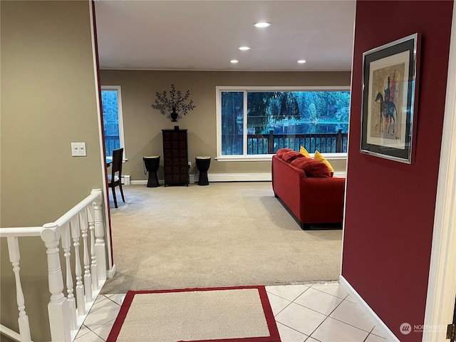 living room with a baseboard radiator and light carpet