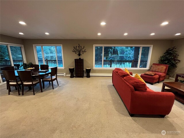 carpeted living room featuring a baseboard heating unit