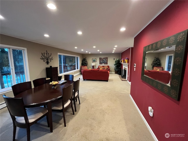 carpeted dining area featuring crown molding