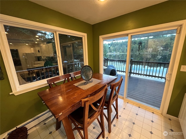 dining space with a baseboard radiator