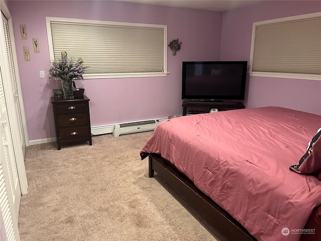 carpeted bedroom with a baseboard radiator