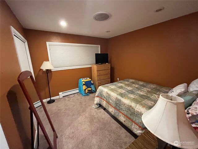 bedroom featuring a baseboard radiator and light colored carpet